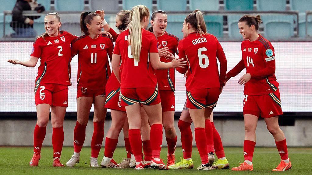 Wales players celebrating Hannah Cain's equaliser.