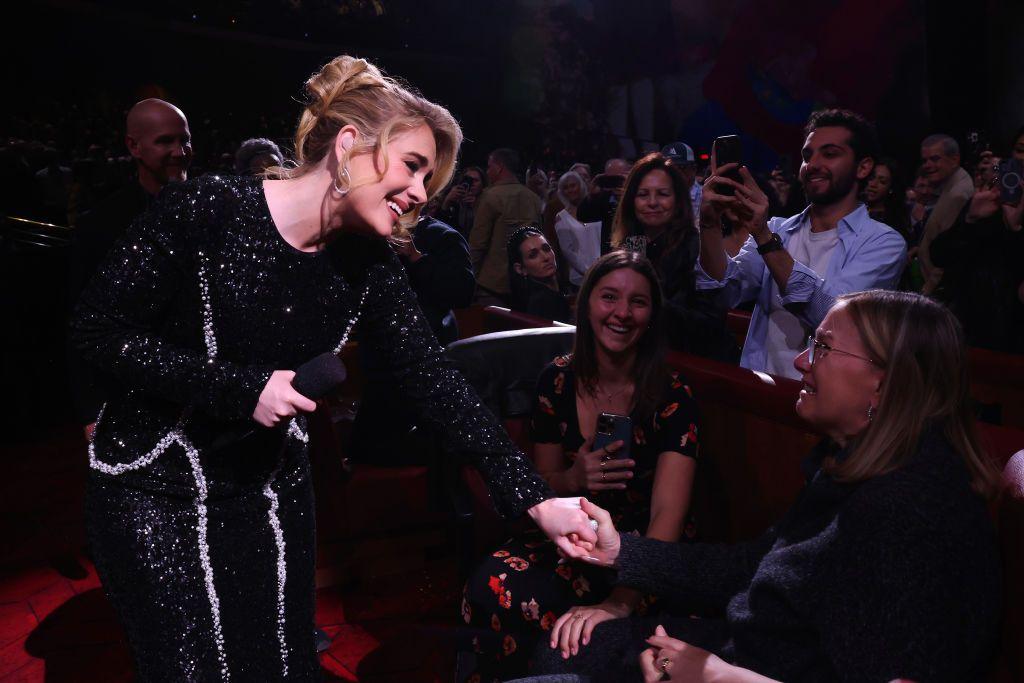 Adele interacts with an audience member during one of her concerts in Las Vegas