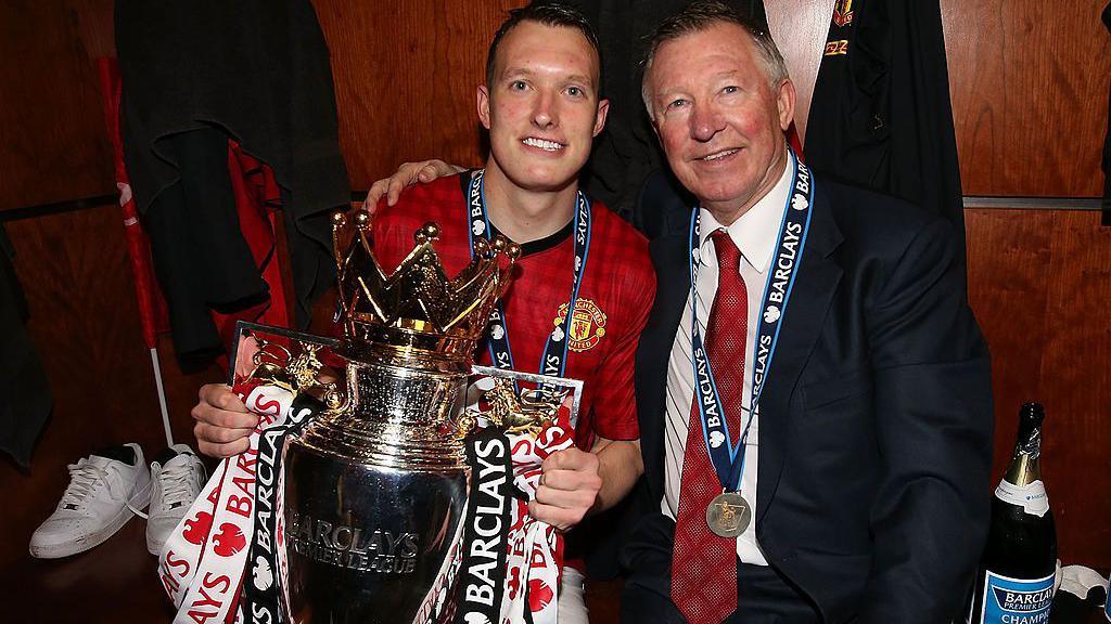 Phil Jones with Sir Alex Ferguson and the Premier League trophy after Manchester United won the title in 2013