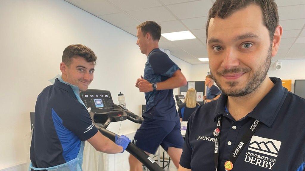 Two University of Derby staff members watching Derby County's Craig Forsyth running on treadmill