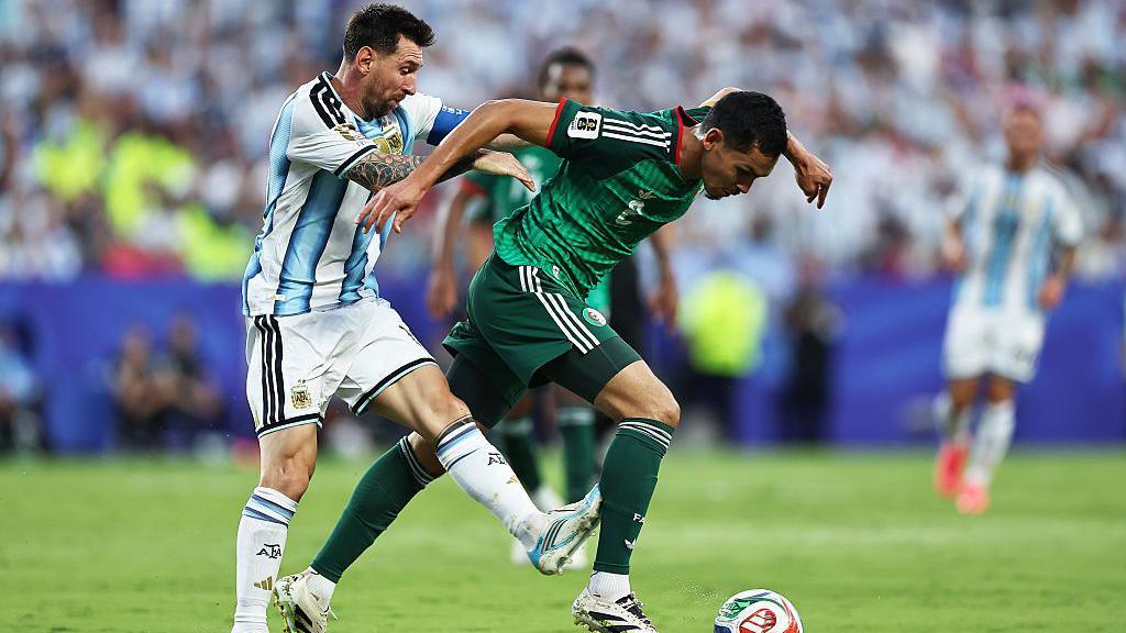 Argentina's Lionel Messi catches Aissa Mandi of Algeria on the back of his calf during the FIFA World Cup 2026 Group J match 