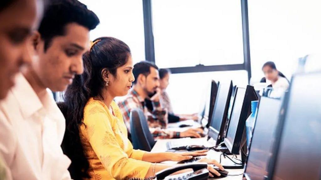 Stock image of employees looking at their computer screens