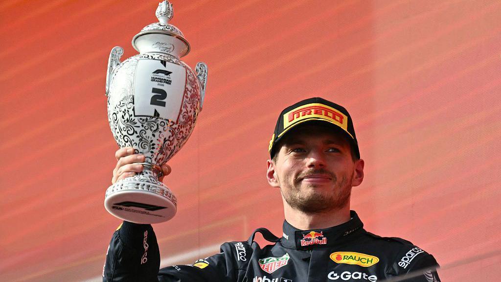 Max Verstappen holds up the second-placed trophy at the Hungarian Grand Prix this season 