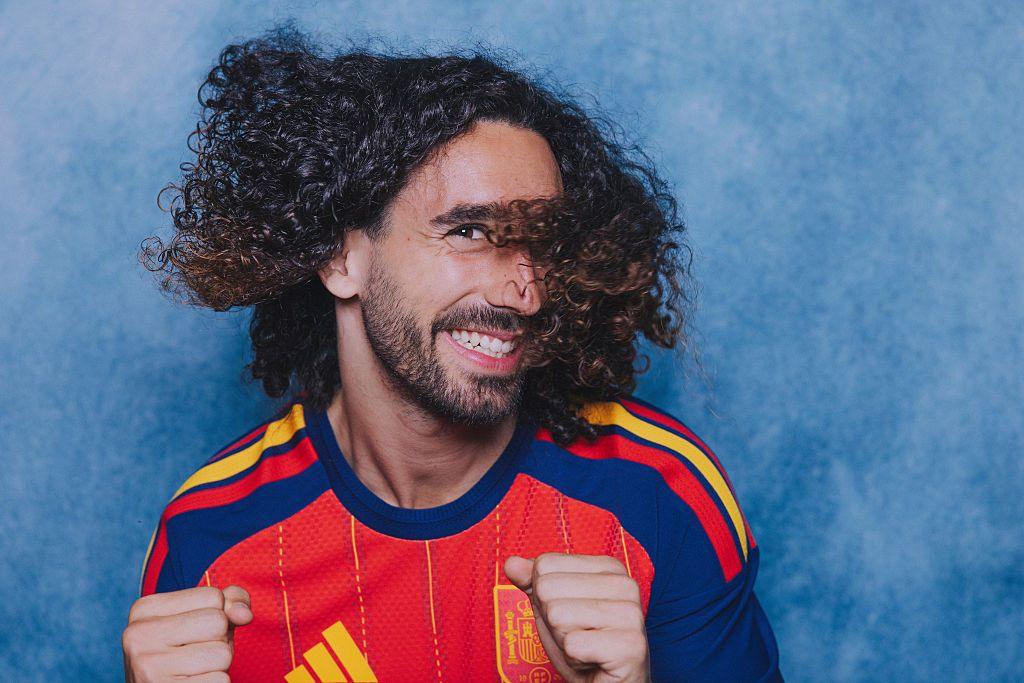 Spanish defender Marc Cucurella poses in a red Spain kit