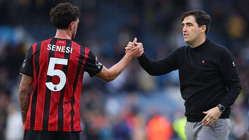 Andoni Iraola shakes hands with Marcos Senesi
