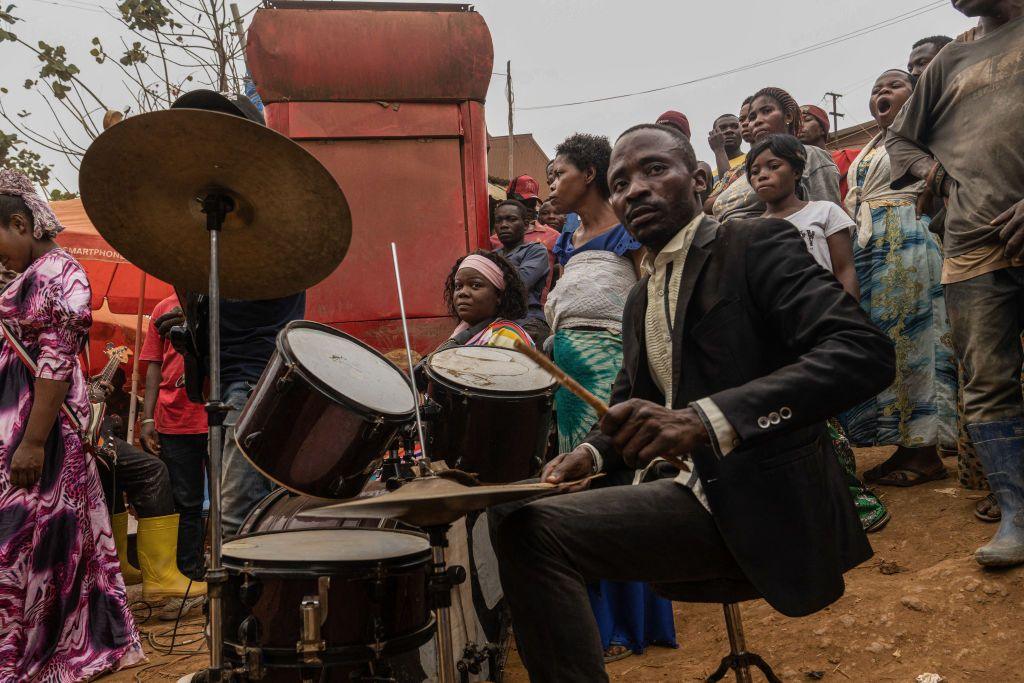 A man plays a drum during an impromptu service in the streets of Kamituga, in South Kivu in the east of the Democratic Republic of Congo on September 20, 2024. 