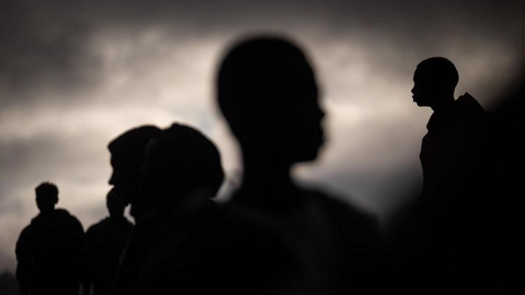 Sub-Saharan migrants walk around the outskirts of Las Raices Camp in Tenerife, Canary Islands, Spain in 2023.