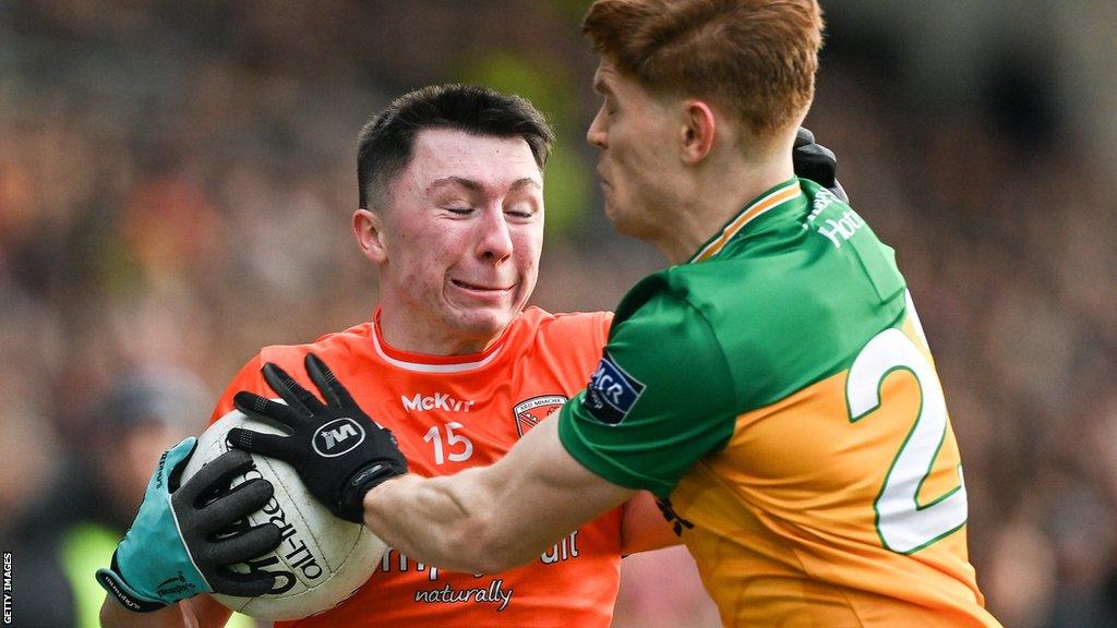 Donegal's Ciaran Moore tackles Armagh's Oisin Conaty in the Division Two top-of-the-table contest at the Athletic Grounds