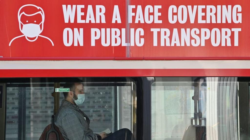 Man on bus with mask sign