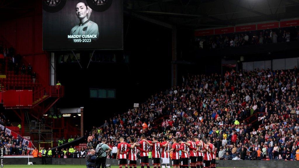 Sheffield United players embrace in a minute's silence following Maddy Cusack's death before their Premier League match against Newcastle in September