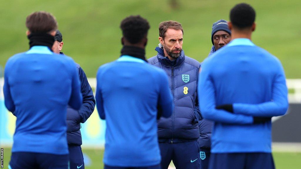 Gareth Southgate speaks to a group of players during England training