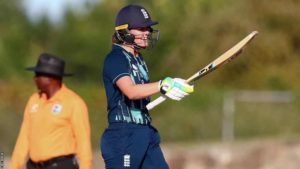 Nat Sciver raising her bat to celebrate her half-century against West Indies