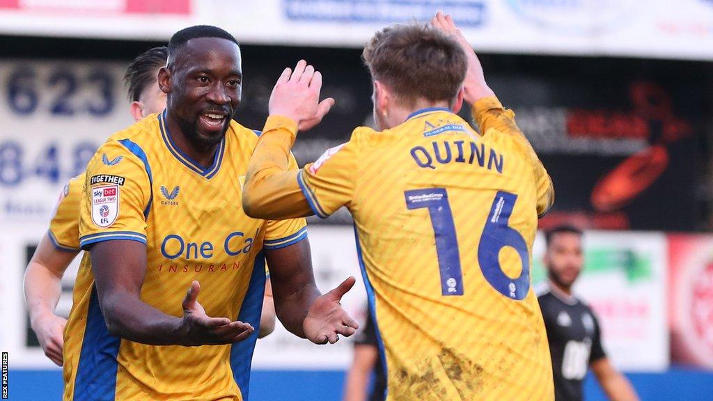 Lucas Akins of Mansfield Town celebrates his goal against Salford