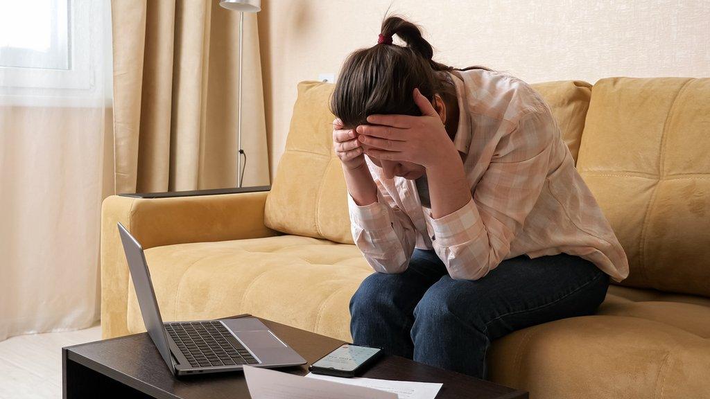 Stock photograph of someone worried about a phone bill