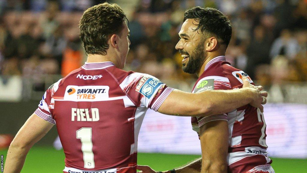 Bevan French and Jai Field celebrate a try with Wigan in 2023