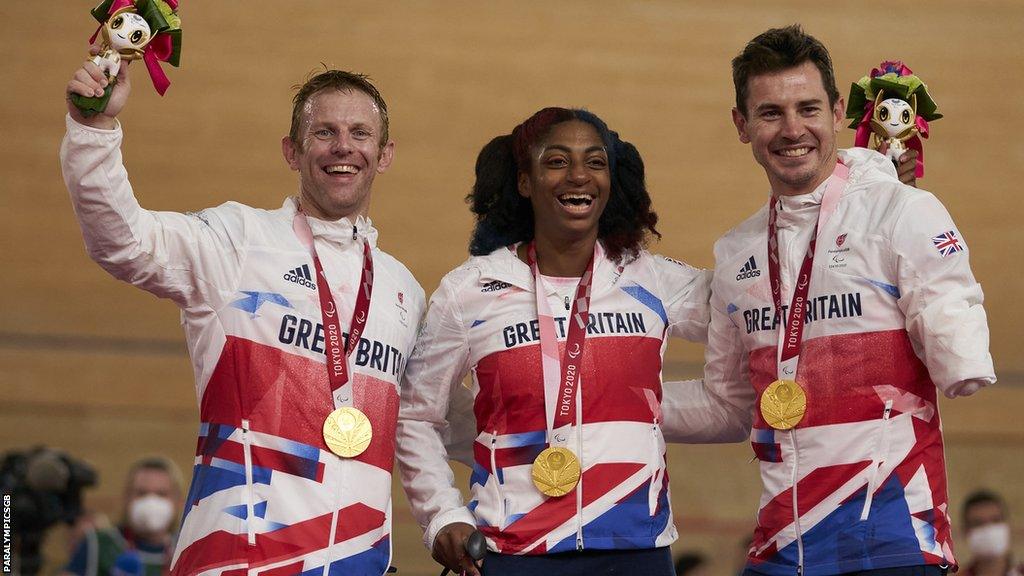 Para cyclists Jody Cundy, Kadeena Cox and Jaco van Gass celebrate their Tokyo team sprint gold