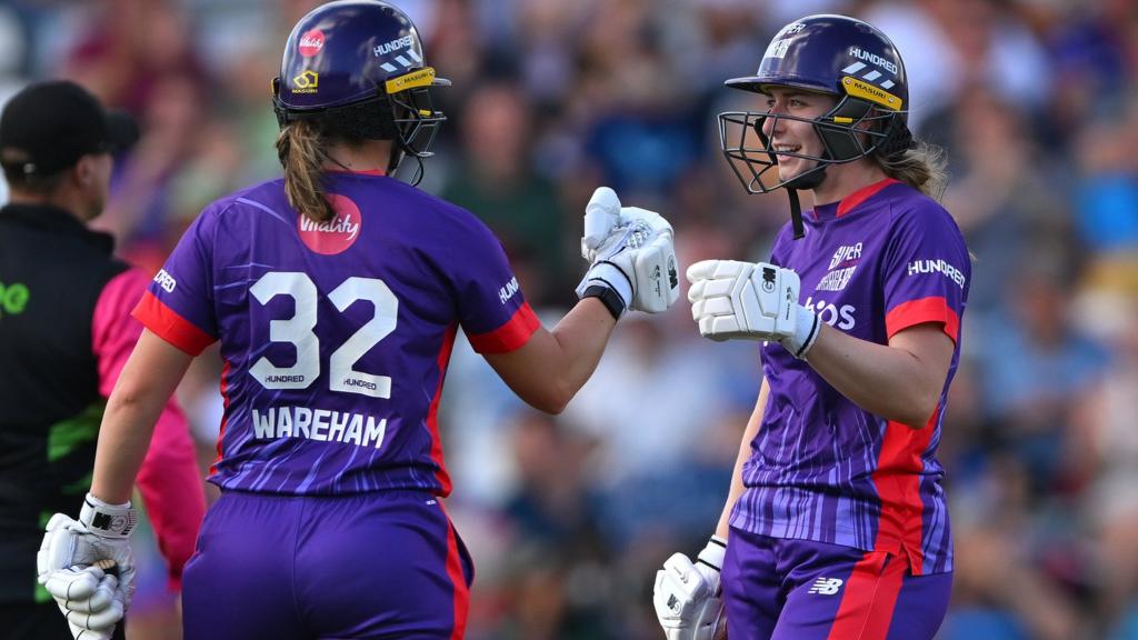 Superchargers batters Georgia Wareham (l) and Marie Kelly punch gloves