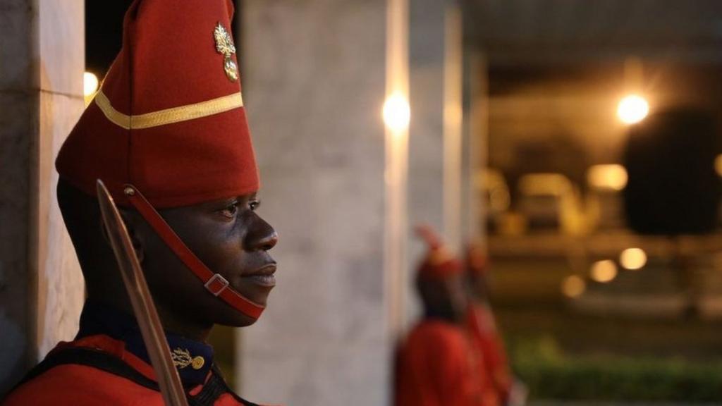 Two guards in Senegal wearing red