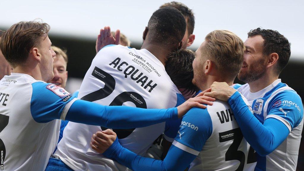 Barrow players celebrating a goal away to Wrexham