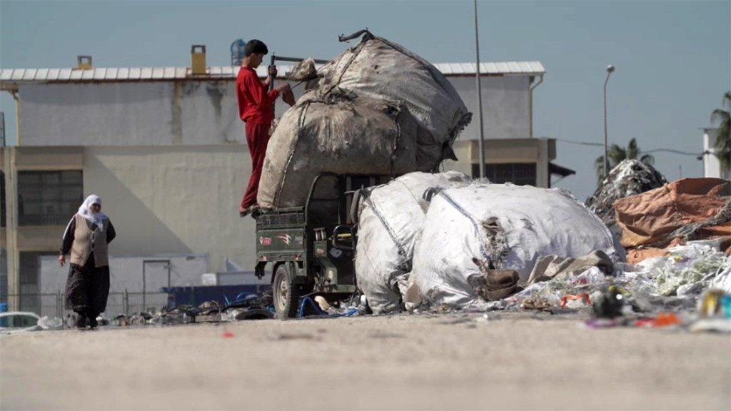 Boy looking through rubbish