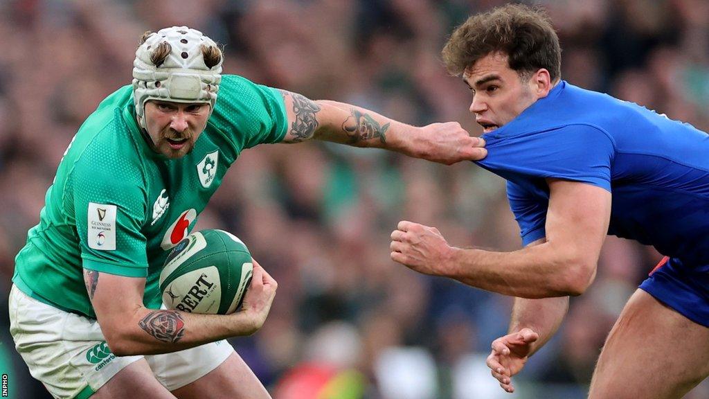 Ireland wing Mack Hansen attempts to fend off France's Damian Penaud during the Six Nations game on 11 February