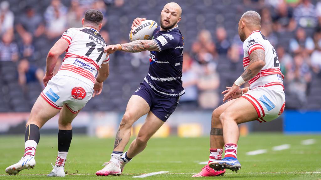 Featherstone's Luke Briscoe fends off Leigh's Joe Wardle