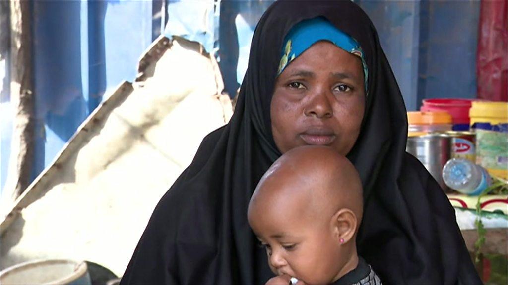 Fowsiya Salah Osman sits with one of her children