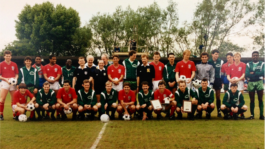 Players of England and Aylesbury United line up at Buckingham Road before a warm-up match on 4 June 1988