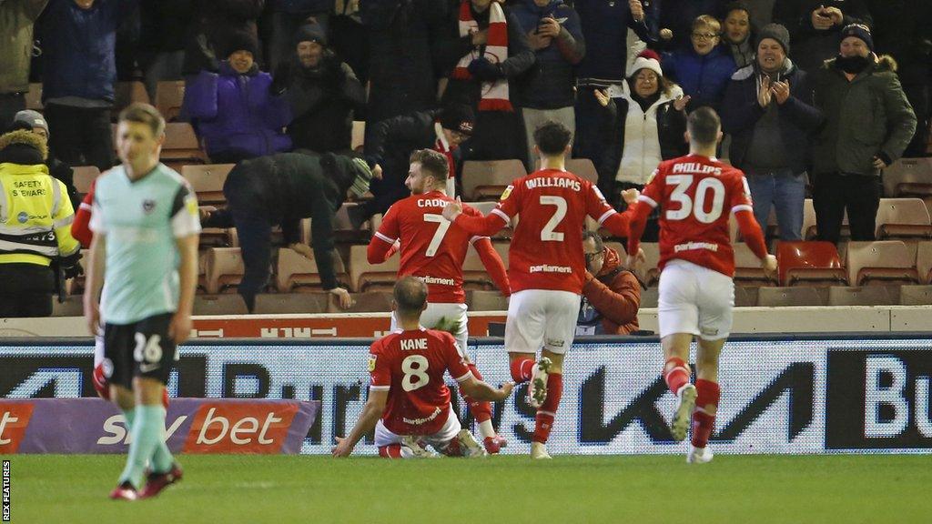 Portsmouth defender Sean Raggett says they will keep pushing for the playoffs despite Barnsley defeat.