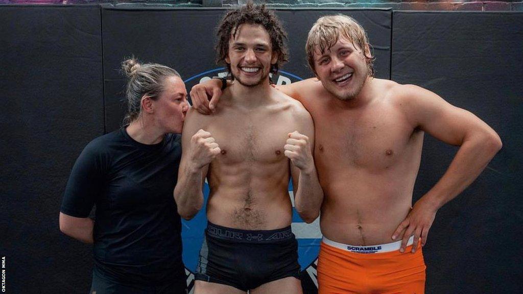 Shem Rock poses for a photo with Molly McCann and Paddy Pimblett.