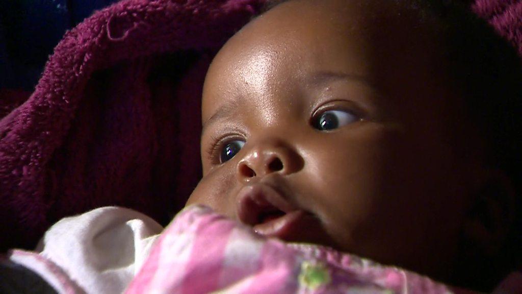 Baby girl in a cot