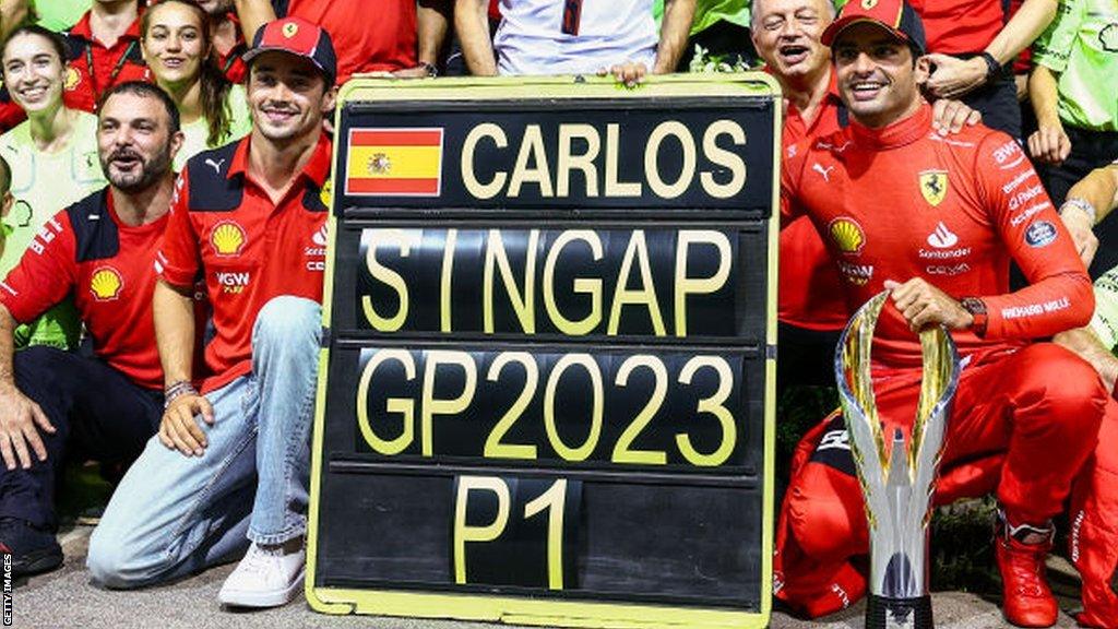 Carlos Sainz celebrates with Ferrari team