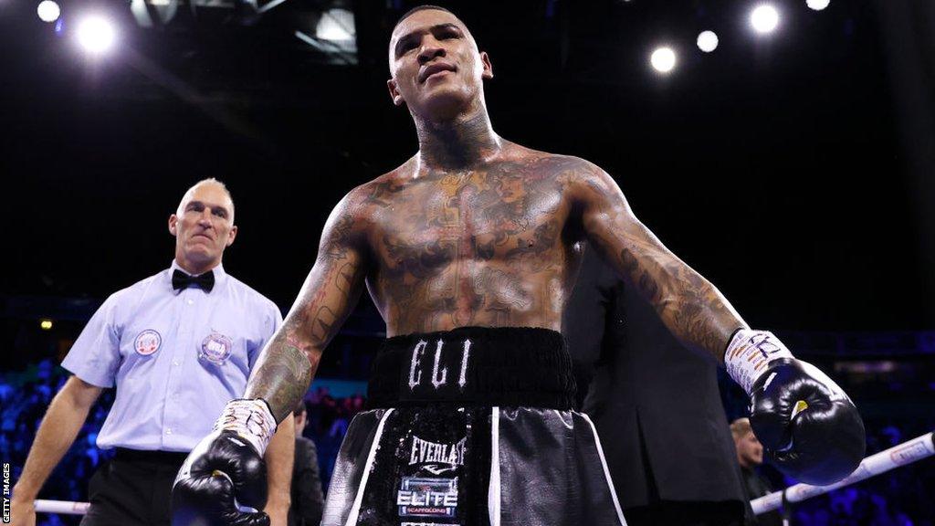 Conor Benn with his arms out during a fight