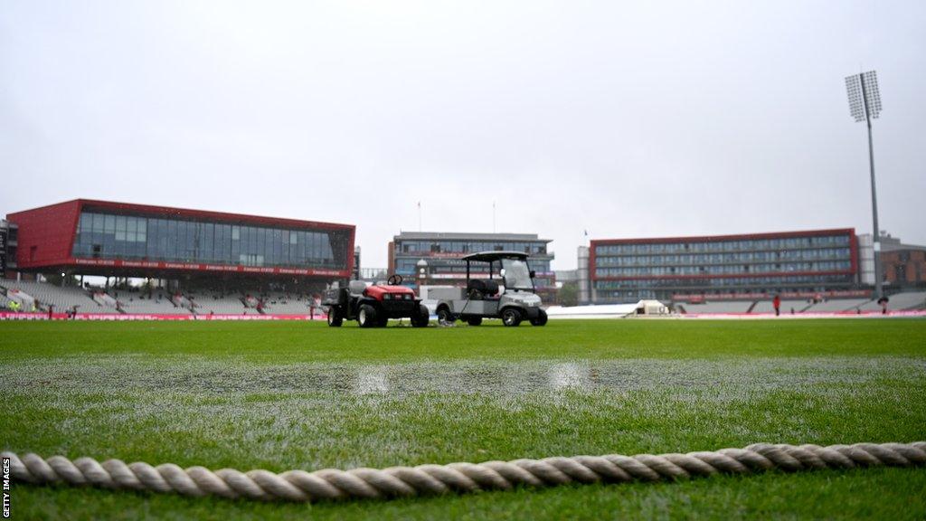 Puddles on the outfield at Old Trafford