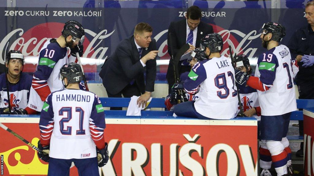 Coach Peter Russell talks to players on the GB bench