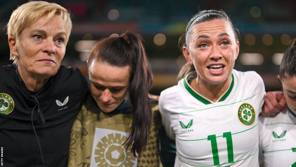 Katie McCabe (right) talks to her team at full-time while Vera Pauw (left) watches on