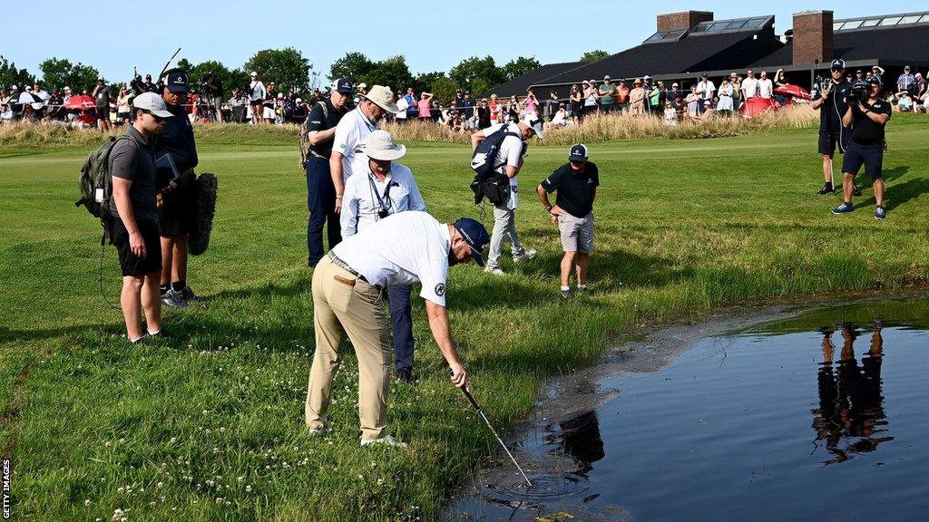 Richie Ramsay fishes his ball out the water in Denmark