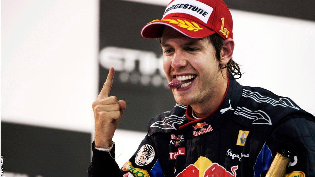 Sebastian Vettel celebrates winning the 2010 Formula 1 world championship while wearing a Bridgestone cap