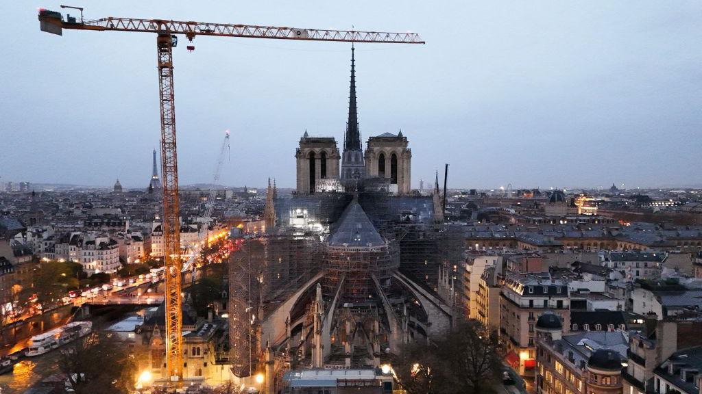 This aerial photograph shows a crane next to scaffolding on Notre-Dame de Paris cathedral as the sun rises a few days before its reopening, on November 25, 2024. 