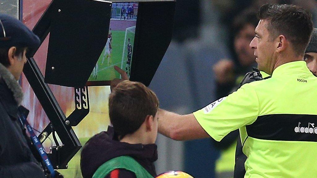 A referee checks a video replay during a Serie A match in Italy