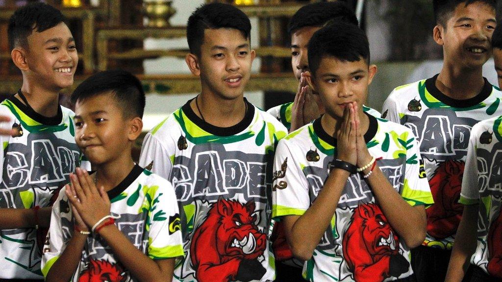 Some of the 12 members of the Wild Boar soccer team, who were rescued from the Tham Luang cave, greet the media