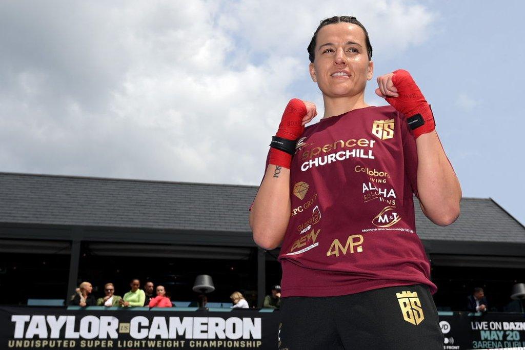 Chantelle Cameron poses for pictures with her fists up at an open workout