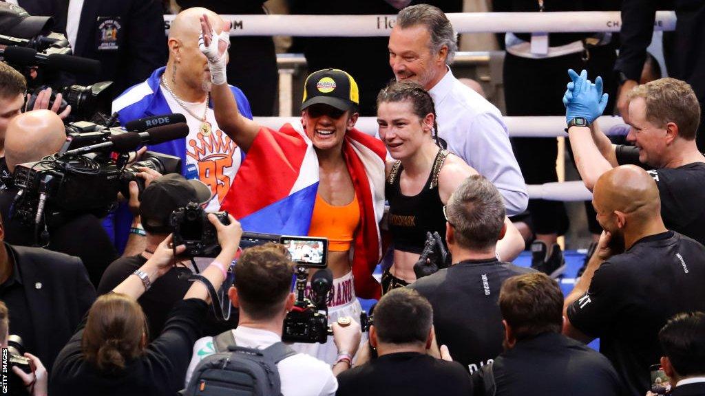 Amanda Serrano and Katie Taylor arm in arm in the ring