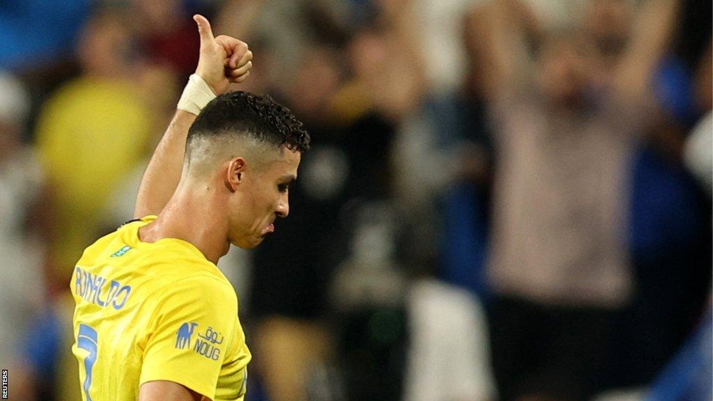 Cristiano Ronaldo giving a thumbs up towards the crowd as he walks off the pitch