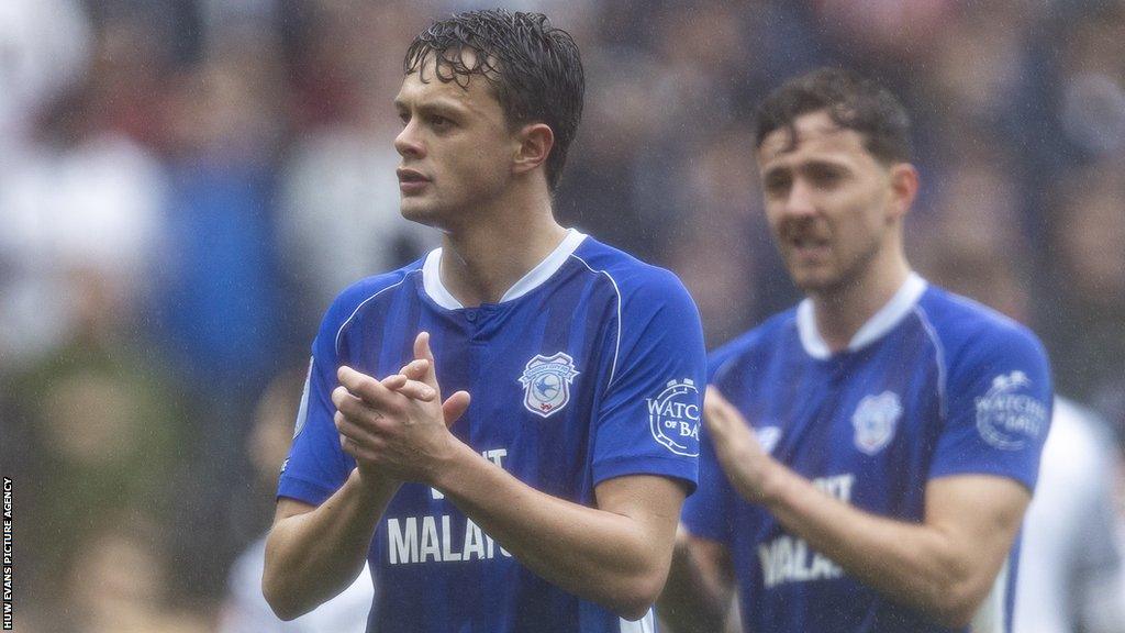 Cardiff players Perry Ng and Ryan Wintle applaud the away supporters at Swansea