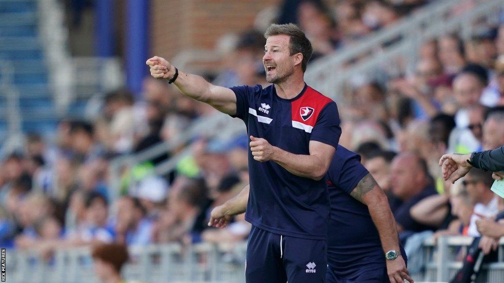 Cheltenham head coach Wade Elliott gives instructions to his team from the touchline in their game away to Portsmouth