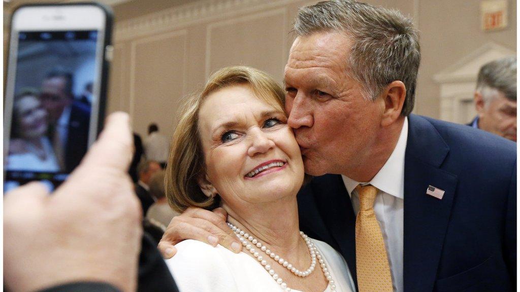 John Kasich kissing a supporter at a fundraising event