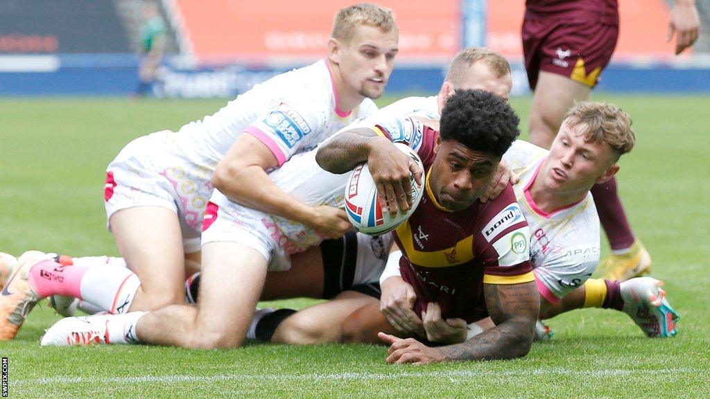 Kevin Naiqama wrestles to get the ball down for Huddersfield