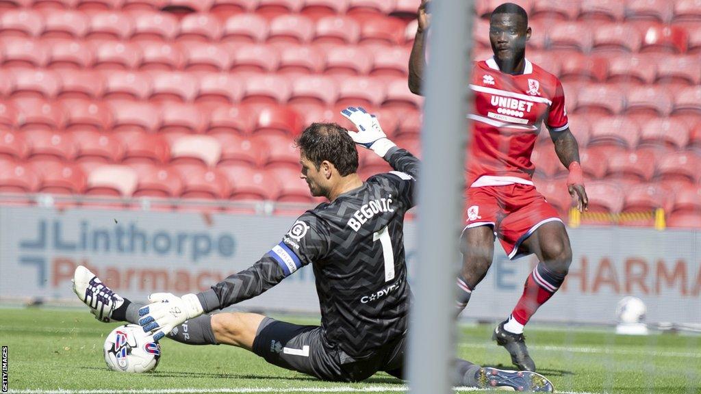 QPR goalkeeper Asmir Begovic saves an effort from Emmanuel Latte Lath