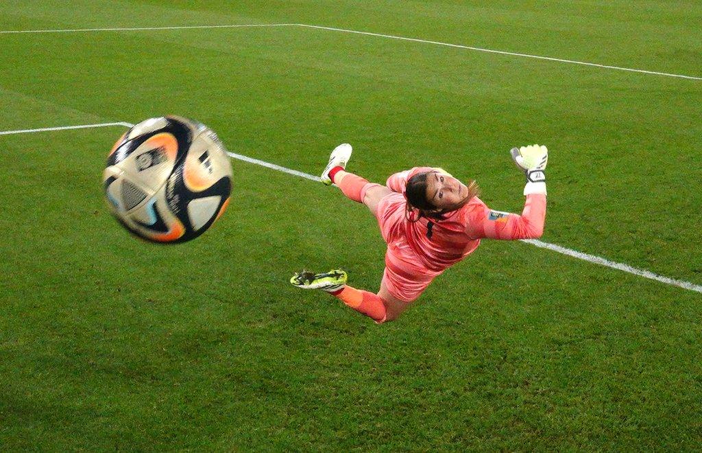 England's Mary Earps dives in vain to keep out Sam Kerr's shot for Australia in the Women's World Cup semi-final in Sydney, Australia